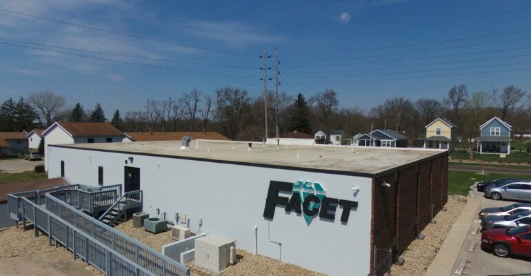 image of back of building with large facet sign