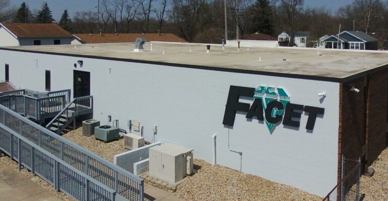 image of back of building with large facet sign