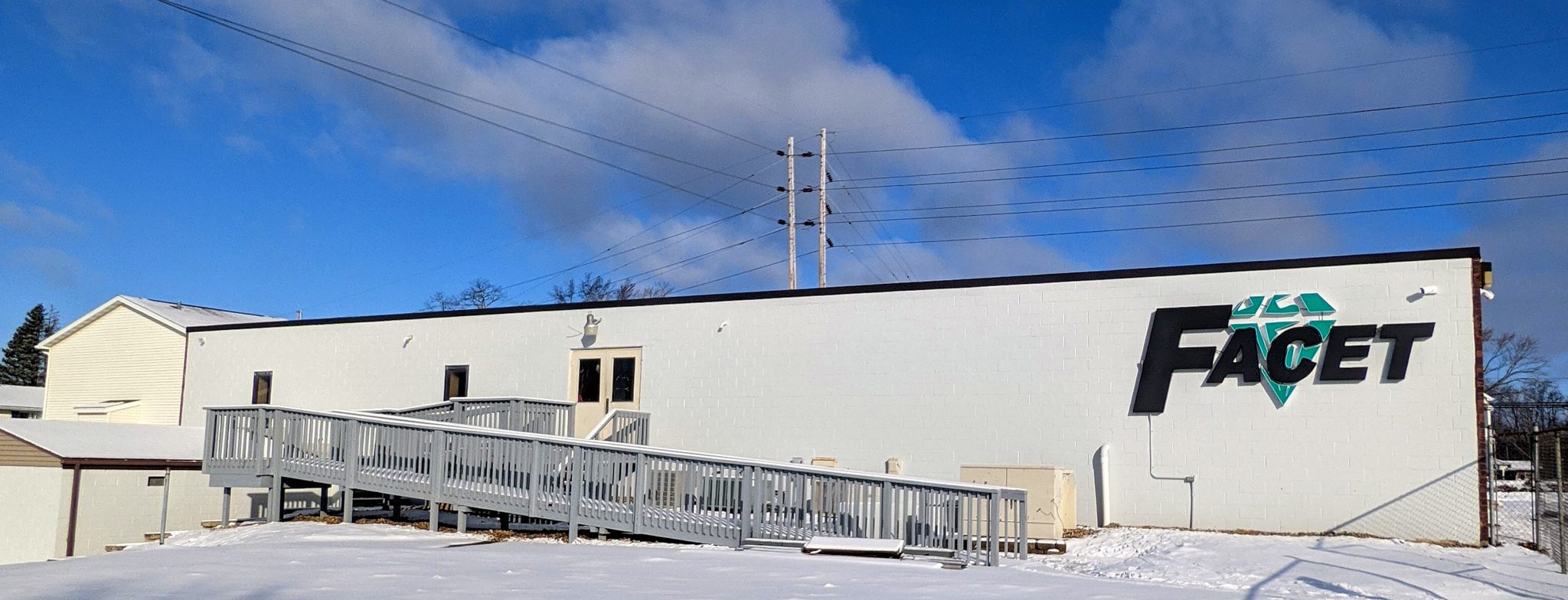 Facet Technologies IT Building - the back of a building with a large sign that reads "Facet"